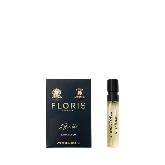 A sample vial of Floris London A Rose For... Eau de Parfum beside its dark blue and gold box—a sophisticated floral and woody scent.