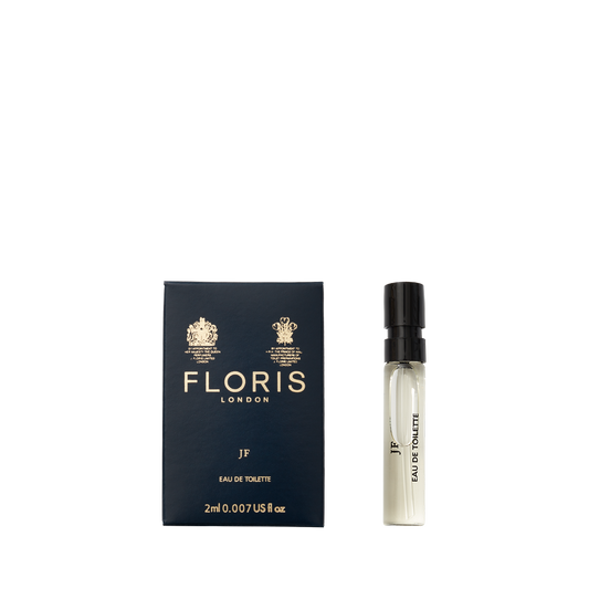 A Floris London JF - Eau de Toilette sample vial next to its dark blue box, featuring a vibrant citrus woody scent for men.