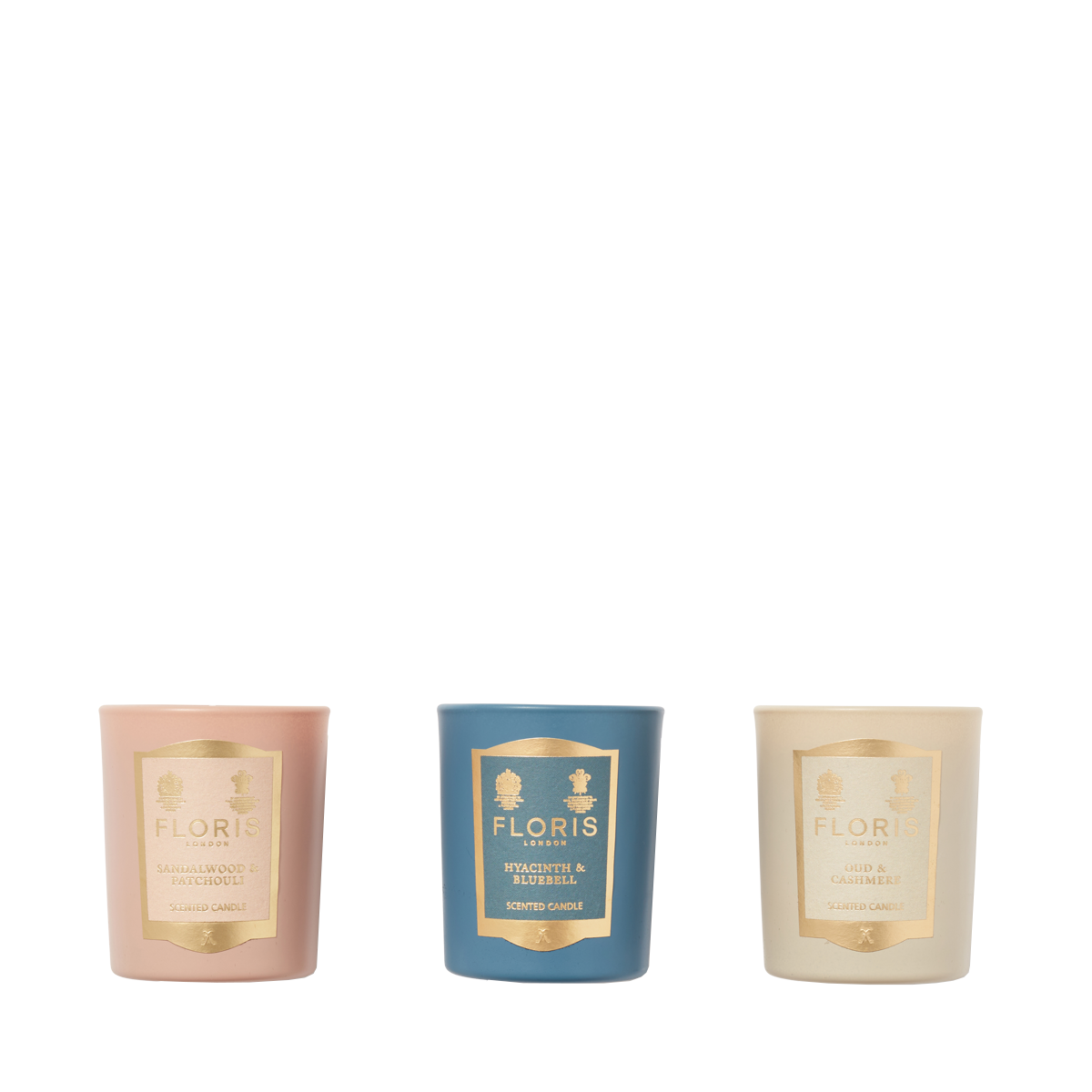 The Floris London Miniature Candle Collection features three scented candles in pink, blue, and cream holders, arranged side by side on white.