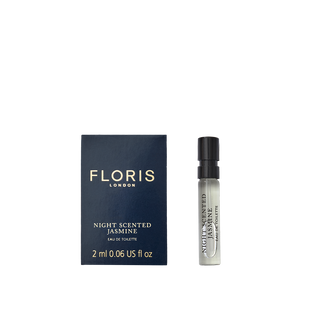 A sample vial of Floris London Night Scented Jasmine Eau de Toilette, featuring white jasmine and neroli blossom, lies next to its dark blue box.