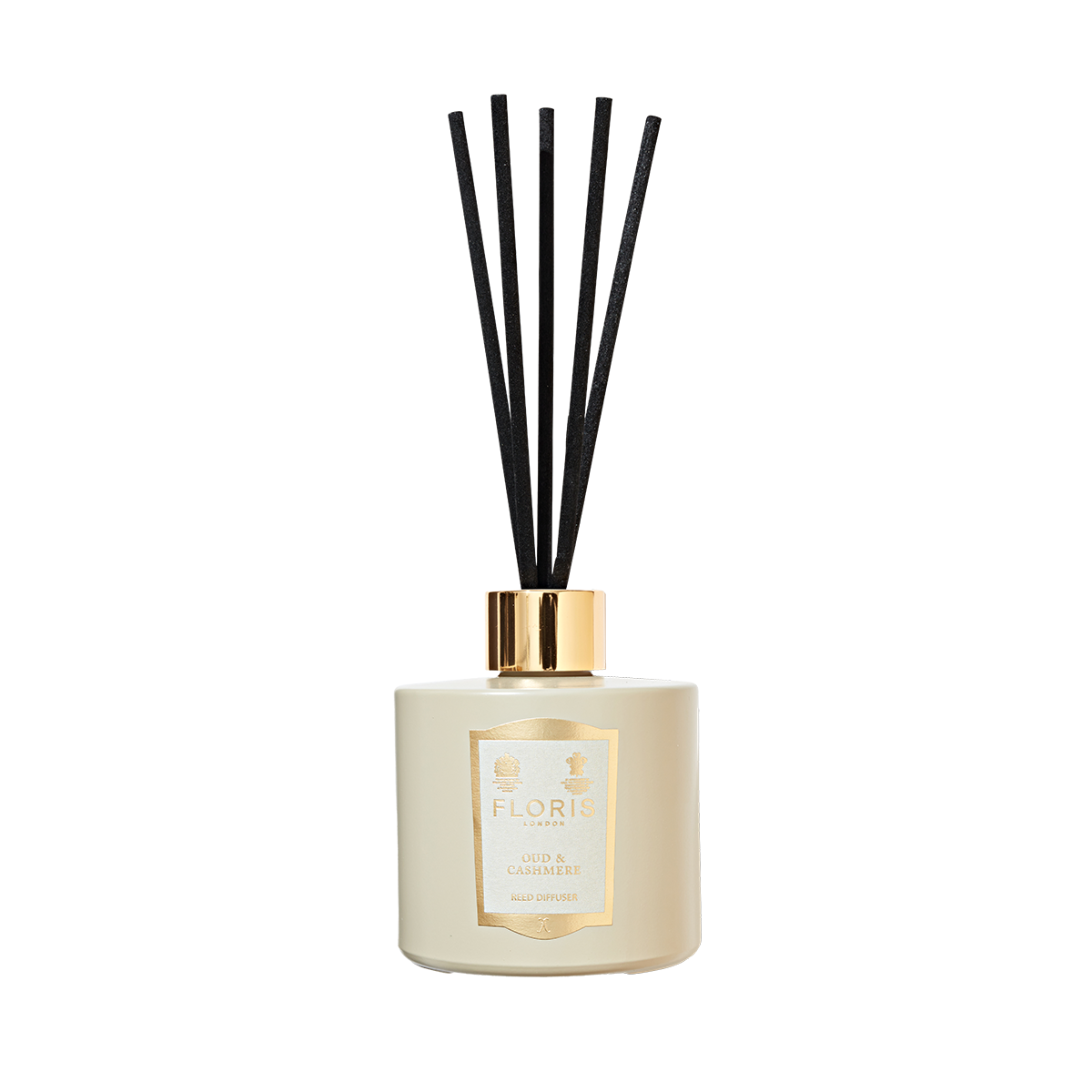 A cream reed diffuser with black sticks and a gold “Floris London” label—Oud & Cashmere is a timeless home fragrance accent.