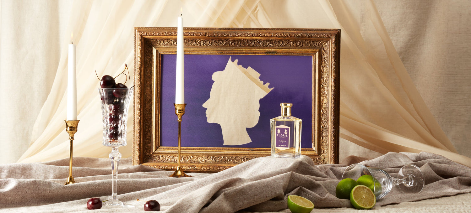 Backdrop of candles, fruits, Platinum 22 and picture frame with Queen Elizabeth II.