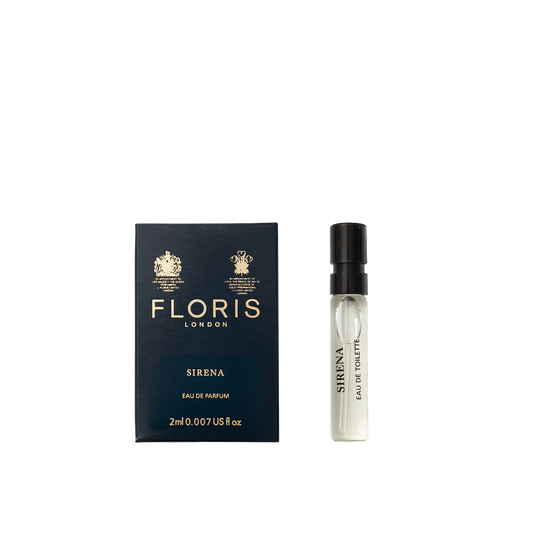 A small vial of Floris London Sirena - Eau de Parfum sits beside its dark blue and gold box, highlighting its fresh floral fragrance.