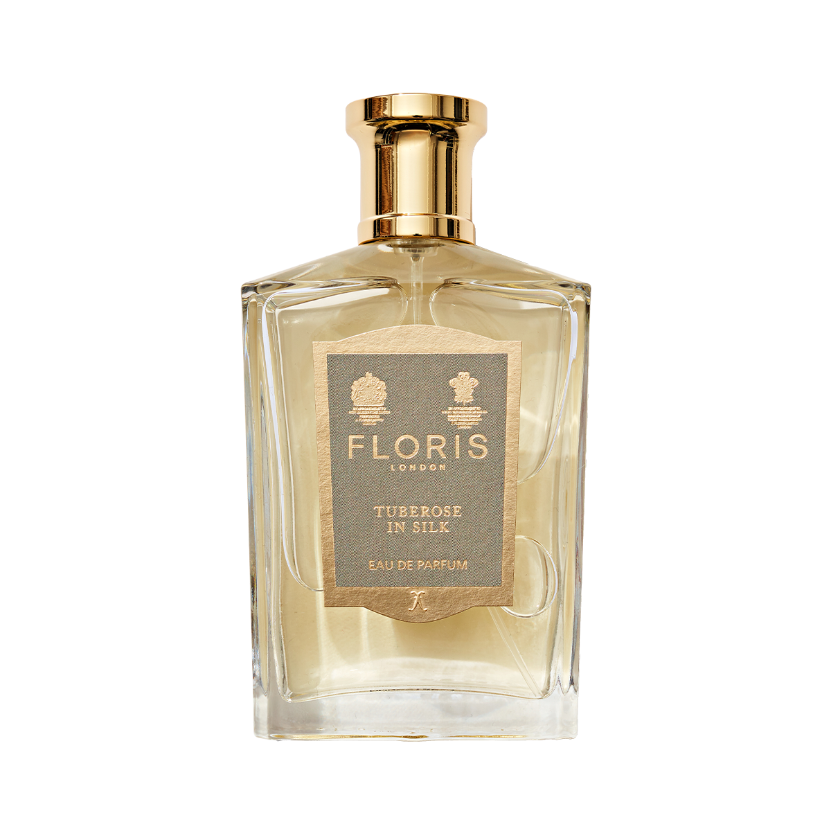 A clear glass bottle of Floris London Tuberose In Silk Eau de Parfum with a gold cap—a truly elegant, floral scent.