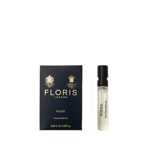 A Floris London Wilde - Eau de Parfum sample vial sits beside its navy blue box, embodying individuality and creative expression.