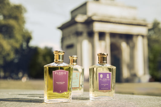 A bottle of Leather Oud, Platinum 22 and Mulberry Fig place upon a stone wall just infront of the Wellington Monument in London.