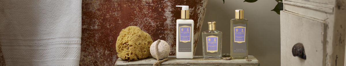 Spa products arranged on a rustic wooden surface with a sponge and towel in the background.