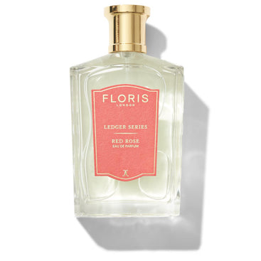 A clear bottle of Floris London's Red Rose eau de parfum with a gold cap and red label.