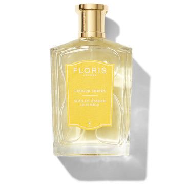 A bottle of Floris London Soulle Ámbar Eau de Parfum with a gold cap and a yellow label.