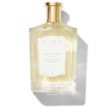 A bottle of Floris London Stephanotis Eau de Parfum with a gold cap and white label.
