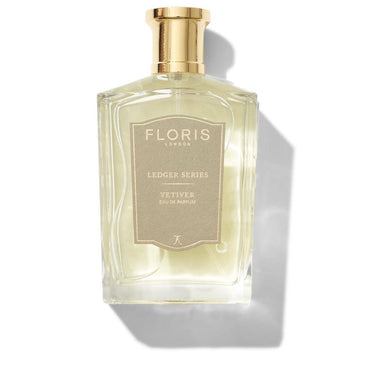 Clear glass bottle of Vetiver Eau de Parfum by Floris London, featuring a gold cap and label, placed against a white background.