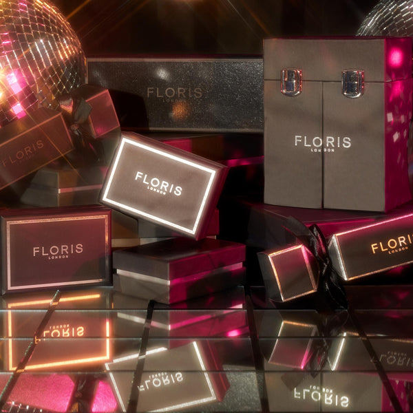 Luxurious Floris London perfume gift boxes surrounded by mirrored surfaces and disco balls in a glamorous display.