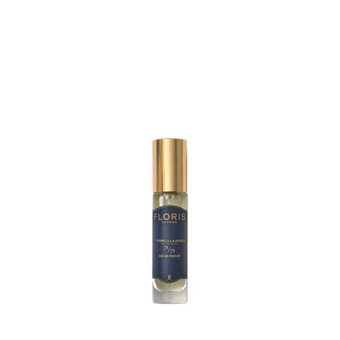 A small Floris London 71/72 Eau de Parfum bottle with a gold cap and dark blue label, featuring a woody scent, on a plain white background.