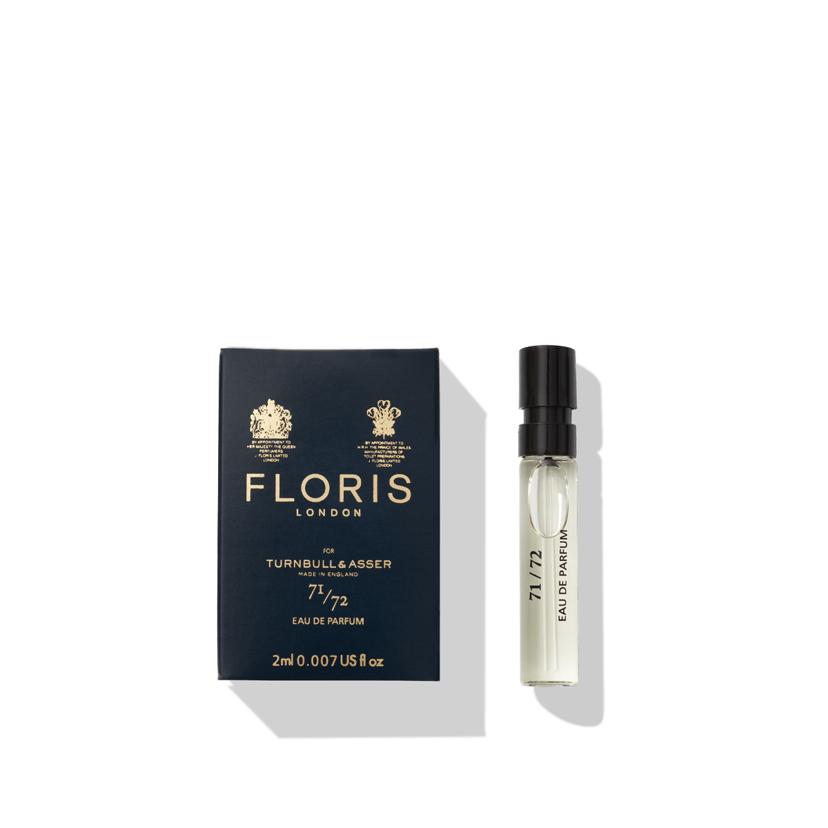 A blue box adorned with "Floris London" and "71/72", evoking the bespoke fashion of Jermyn Street, sits next to a small clear perfume vial labeled "71/72 - Eau de Parfum," a distinguished fragrance for men by Floris London.