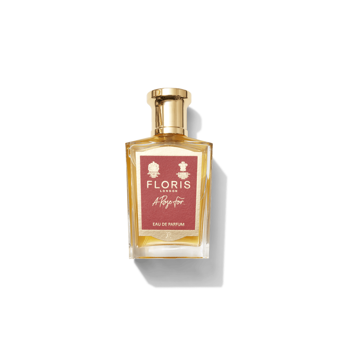 A glass bottle of "A Rose For... - Eau de Parfum" by Floris London features a gold cap and red label against a white background, offering a contemporary fragrance that evokes personal attachment to scent.