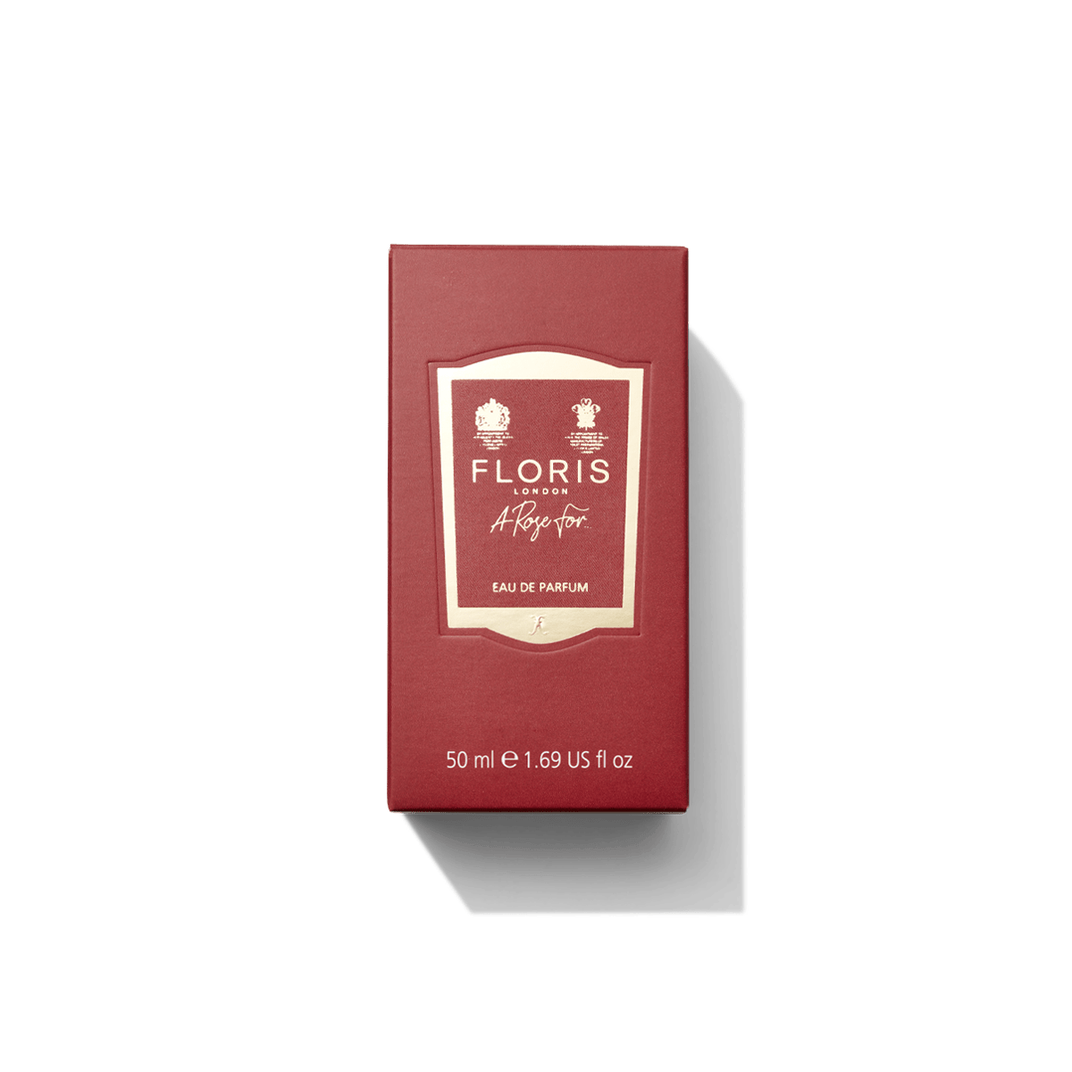 A red box of "A Rose For... - Eau de Parfum" by Floris London, featuring a beige label and containing 50 ml (1.69 fl oz), offers a contemporary fragrance with hints of amber rose, evoking a personal attachment to scent.