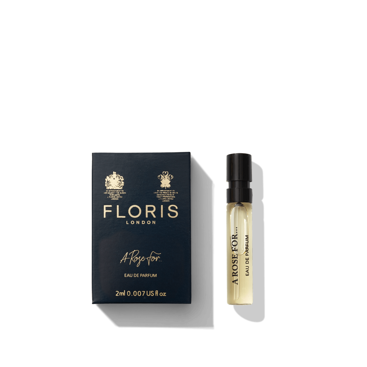 A sample of Floris London's "A Rose For..." Eau de Parfum sits elegantly next to its black and gold packaging, embodying a personal attachment to scent with its contemporary fragrance.