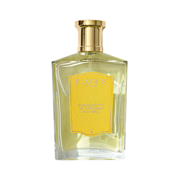 A clear glass bottle of Floris London Bergamotto di Positano Eau de Parfum with a gold cap and yellow label, featuring fresh bergamot and marine notes.