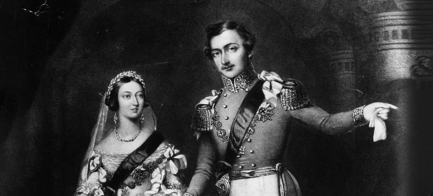 A black-and-white historical portrait of a man and woman dressed in ornate, traditional attire.