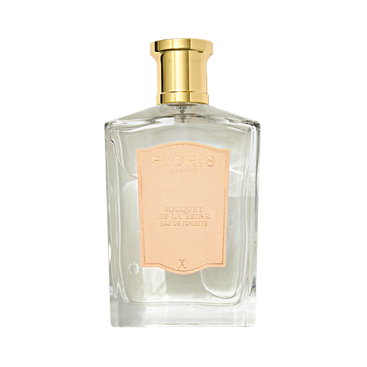 A clear glass Floris London Bouquet de La Reine Eau de Toilette bottle with a gold cap and pale pink label, featuring a fruity floral scent.