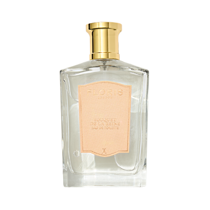 A clear glass Floris London Bouquet de La Reine Eau de Toilette bottle with a gold cap and pale pink label, featuring a fruity floral scent.