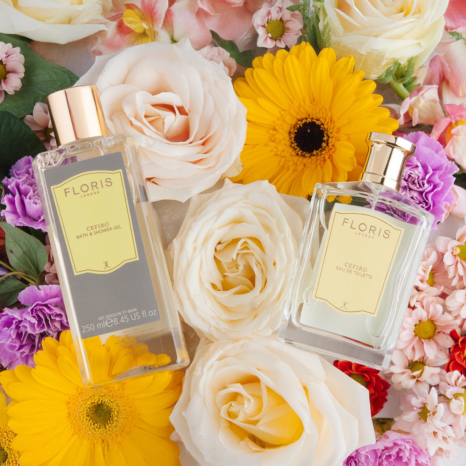 Two Floris London Cefiro Mother's Day Pairing bottles surrounded by colorful flowers, including roses and daisies.