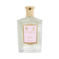 A clear glass bottle of Floris London Cherry Blossom - Eau de Parfum with a gold cap and pink label, capturing the cherry blossom fragrance.