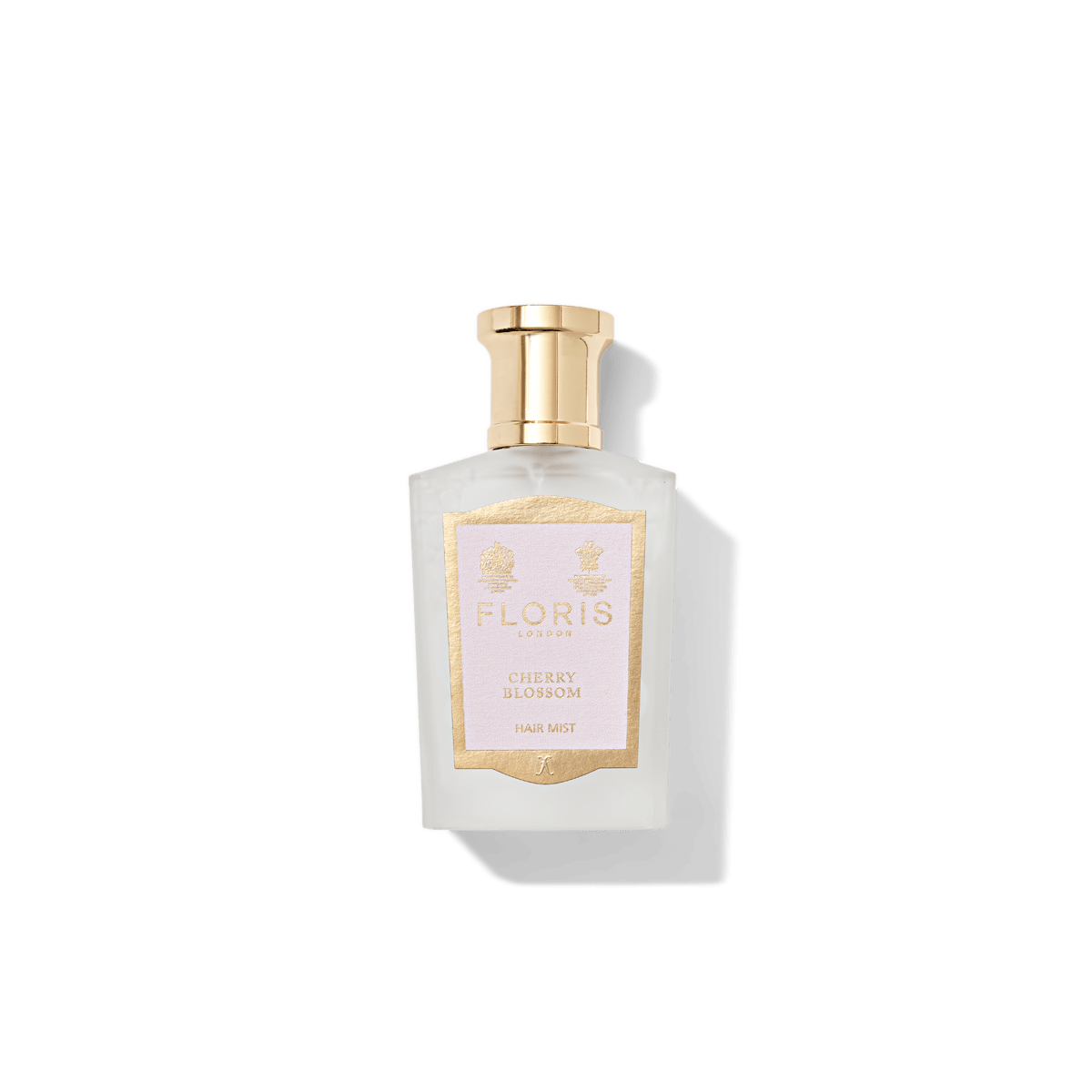 A bottle of Floris London US Cherry Blossom Hair Mist 50ml, featuring a gold cap, exudes a delicate soft floral scent, perfect for adding a touch of elegance.