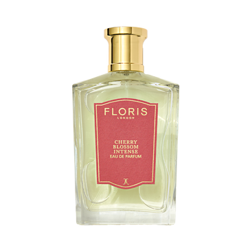 A bottle of Floris London Cherry Blossom Intense Eau de Parfum features a gold cap, pink label, and a vibrant floral-fruity fragrance.