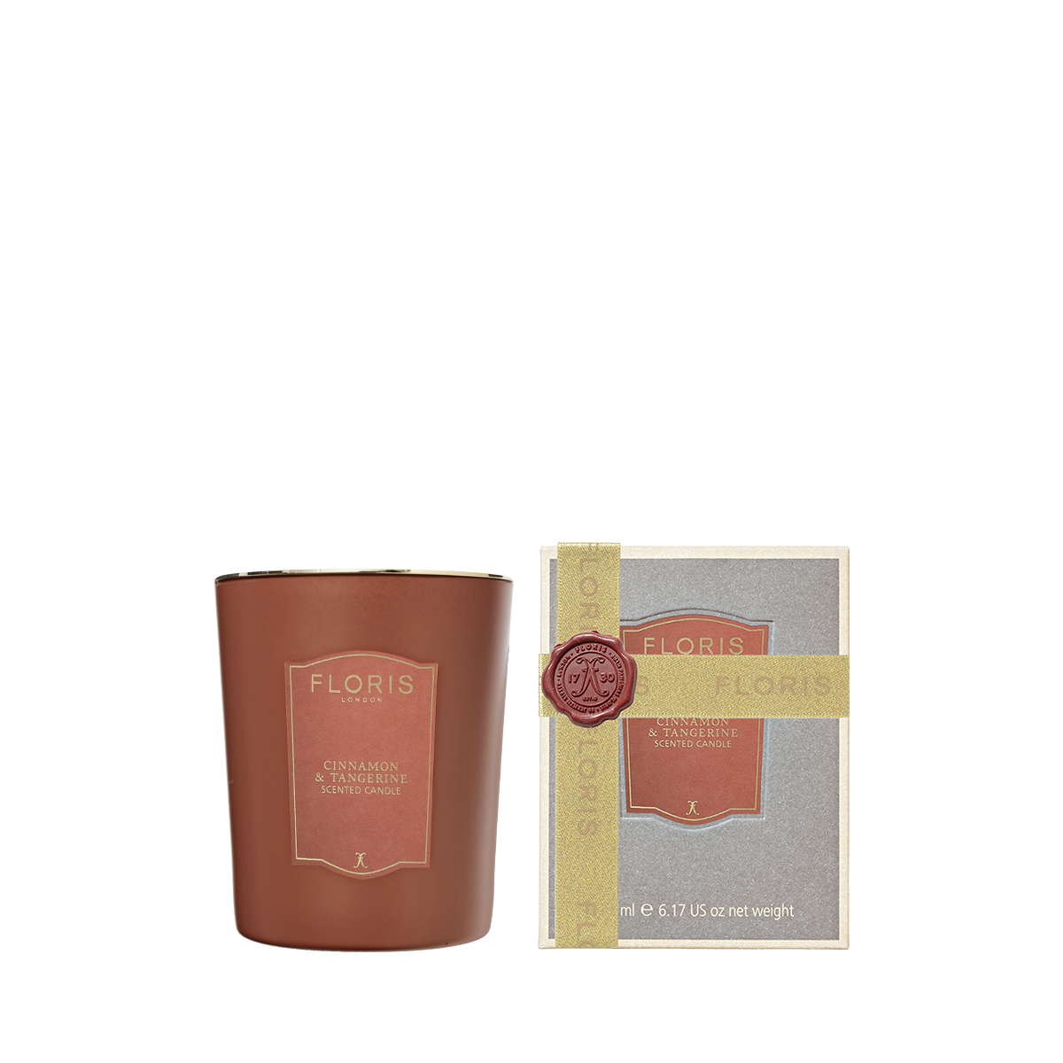 A Cinnamon & Tangerine - Scented Candle 175g in a brown glass jar next to its boxed packaging with a wax seal.