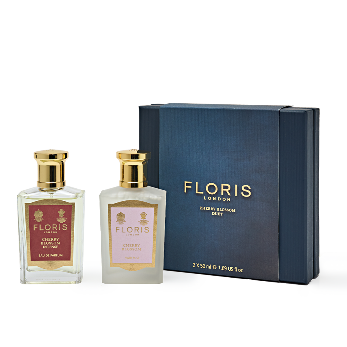 The Cherry Blossom Duo by Floris London features two perfume bottles nestled beside a dark blue gift box, forming an elegant gift set.