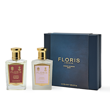 The Cherry Blossom Duo by Floris London features two perfume bottles nestled beside a dark blue gift box, forming an elegant gift set.