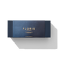 Floris London's Miniature Candle Collection is elegantly presented in a blue box adorned with gold text, featuring a stunning assortment of beautifully scented miniature candles against a white background.