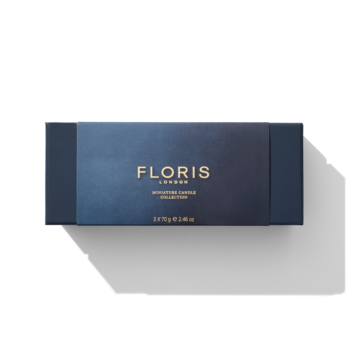 Floris London's Miniature Candle Collection is elegantly presented in a blue box adorned with gold text, featuring a stunning assortment of beautifully scented miniature candles against a white background.