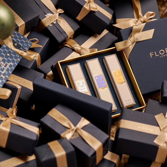 The Perfumer's Trilogy: For Her by Floris London comes in a black and gold box with an elegant gift box adorned in gold ribbons, offering a set of three floral fragrances perfect for her during this season of celebration.