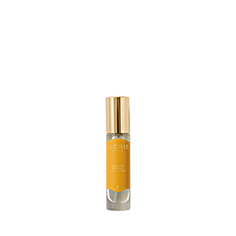 A small glass Eau de Parfum bottle from Floris London with a gold cap and yellow label, "Golden Amber," featuring notes of golden amber.