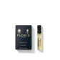 A navy blue box labeled "Honey Oud - Eau de Parfum" by Floris London from the Private Collection sits next to a small perfume vial.