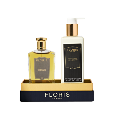 Floris London US Sweet Lux | Honey Oud Duo set with Eau de Parfum and moisturizer in a black and gold box.