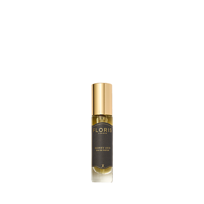 A small bottle of Floris London Honey Oud - Eau de Parfum, featuring rich oud oil and English honey, with a gold cap and dark label.