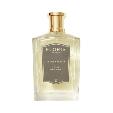 A clear bottle of Floris London Islay Eau de Parfum with a gold cap, gray label, and a peaty smoky scent.