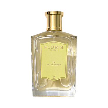 A clear glass bottle of Floris London JF - Eau de Toilette, a men’s citrus woody scent, featuring a gold cap and yellow label.