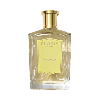 A clear glass bottle of Floris London JF - Eau de Toilette, a men’s citrus woody scent, featuring a gold cap and yellow label.