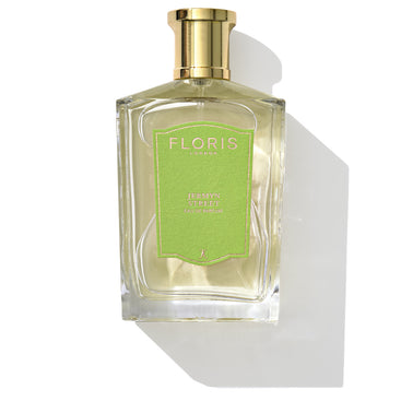 A bottle of Jermyn Street - Eau de Parfum from Floris London, featuring a green label and gold cap, stands elegantly against a white background. Its scent profile includes the earthy richness of vetiver.