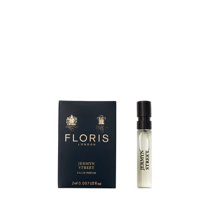 A Floris London Jermyn Street - Eau de Parfum vegan sample vial shown next to its dark blue box with gold text and logos.