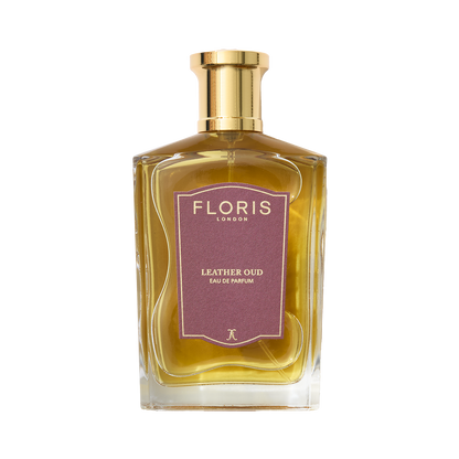 A bottle of Floris London Leather Oud - Eau de Parfum features a gold cap, purple label, and rich oud oil notes.