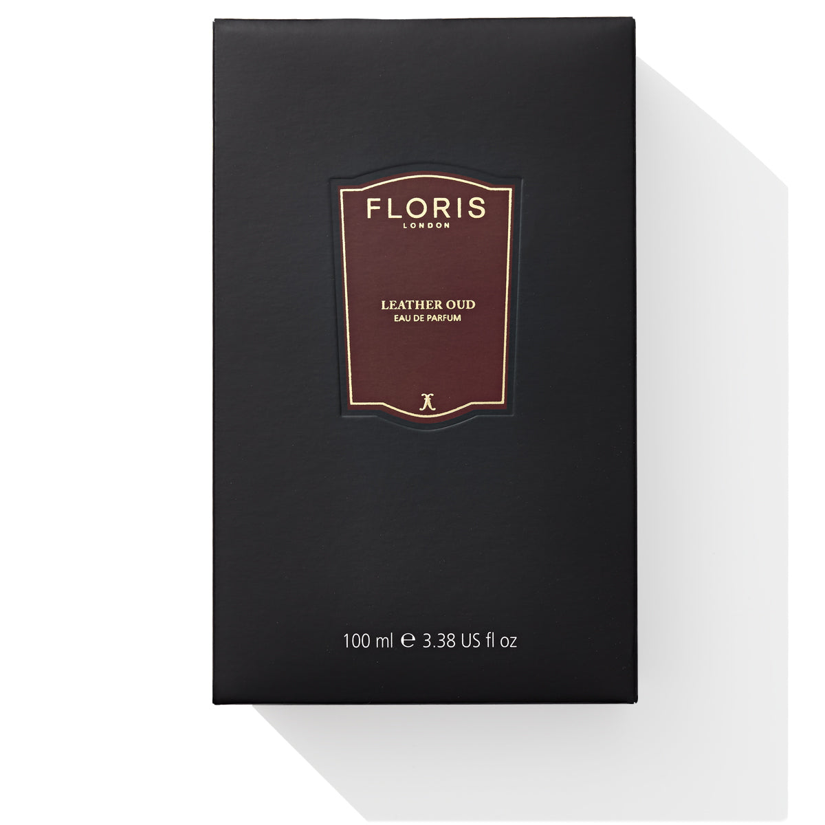 A black box of Floris London's Leather Oud Eau de Parfum, 100 ml, is elegantly displayed against a crisp white background.