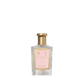 A clear glass bottle of Floris London Lily - Bath Essence with a gold cap, pink label, and a delicate lily scent.