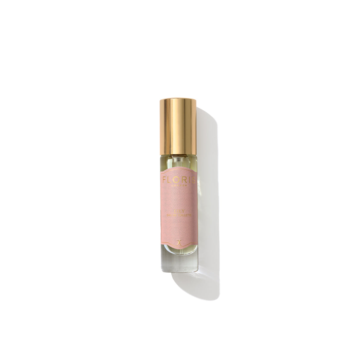 A small glass bottle with a golden cap, containing Lily - Eau de Toilette by Floris London, labeled with a pink and gold design on a white background, emits an enchanting floral fragrance reminiscent of lily of the valley.