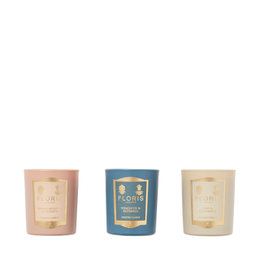 The Floris London Miniature Candle Collection features three scented candles in pink, blue, and cream holders, arranged side by side on white.