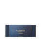 The Floris London Miniature Candle Collection features exquisite miniature scented candles in a dark blue rectangular box with gold text.